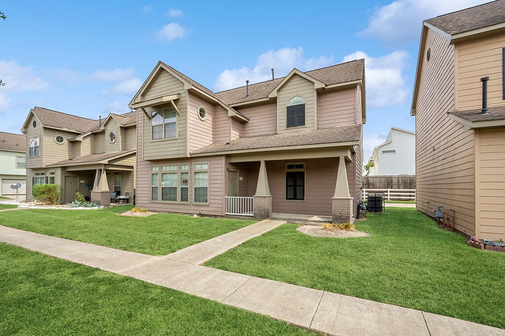 Apartments with lush landscaping at Fountains at Tidwell and The Enclave in Houston TX